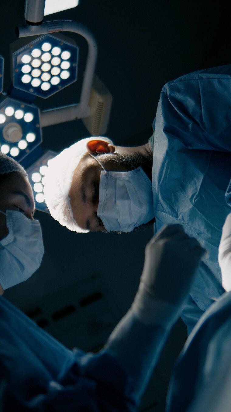 Surgical team during a procedure, under the operating light