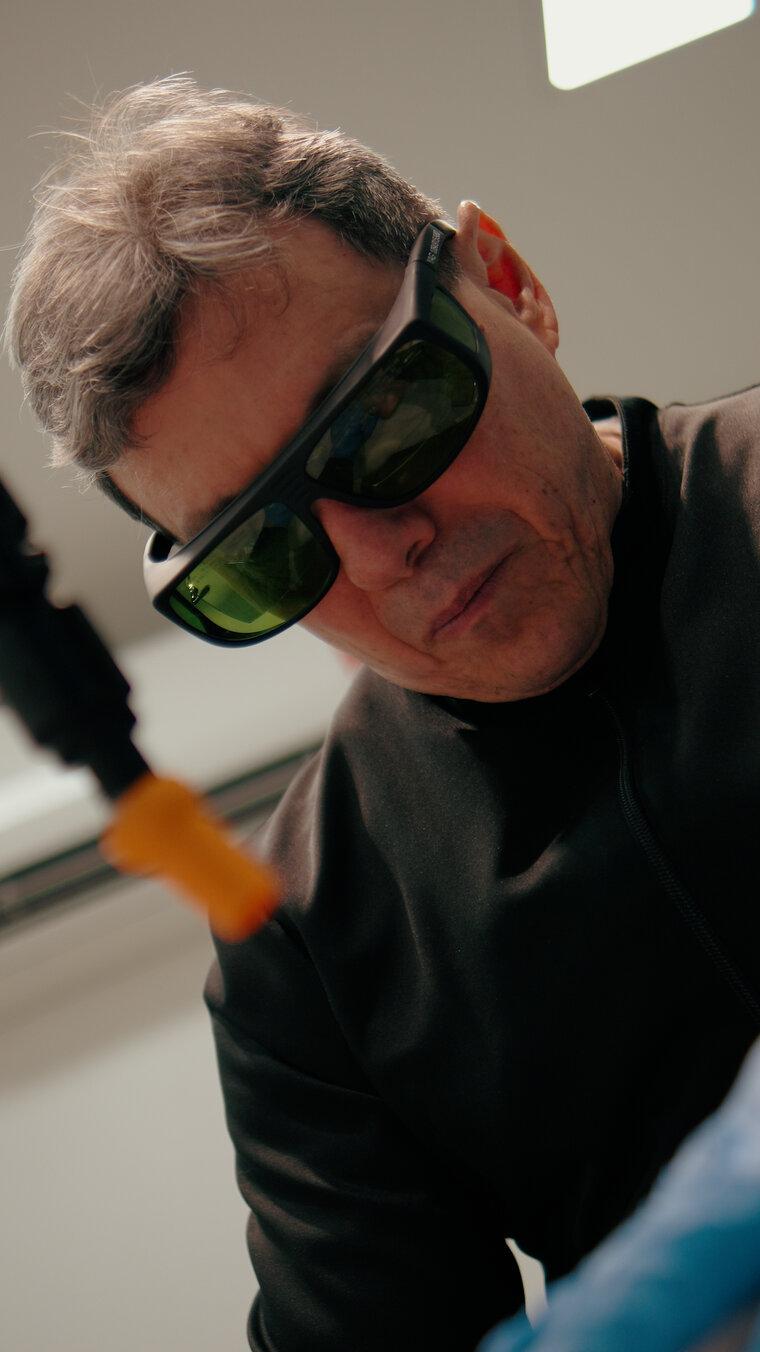 Physician wearing protective eyewear during a laser procedure